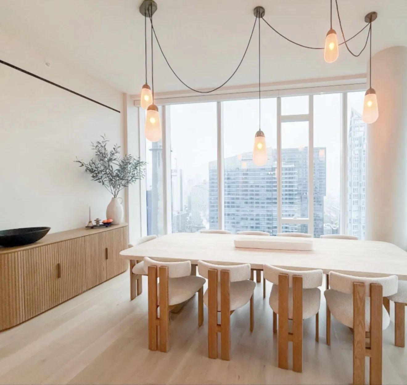 Manhattan dining room with pendant lights and skyline views