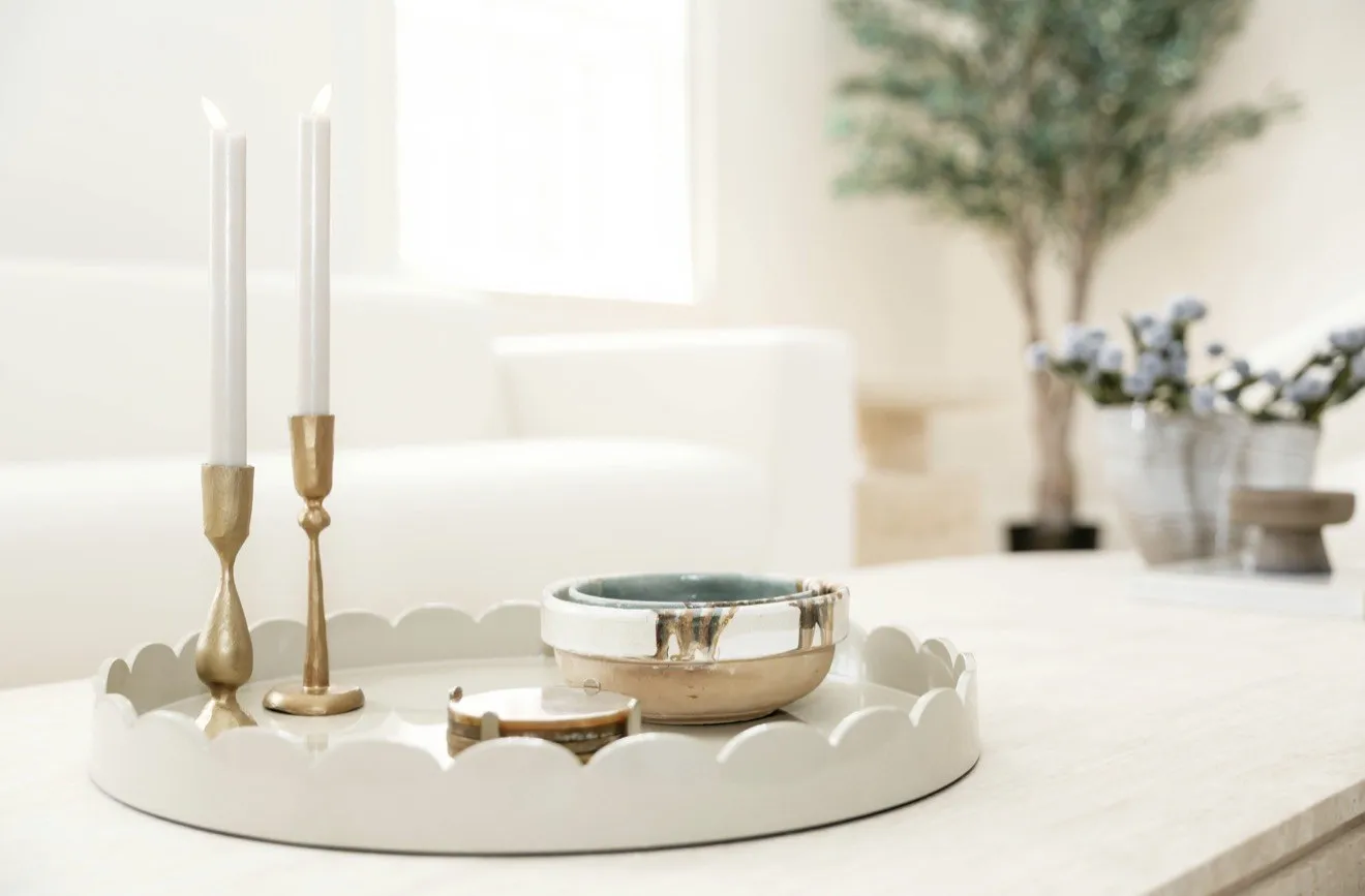 Scalloped tray with brass candlesticks and a ceramic bowl in a Short Hills living room