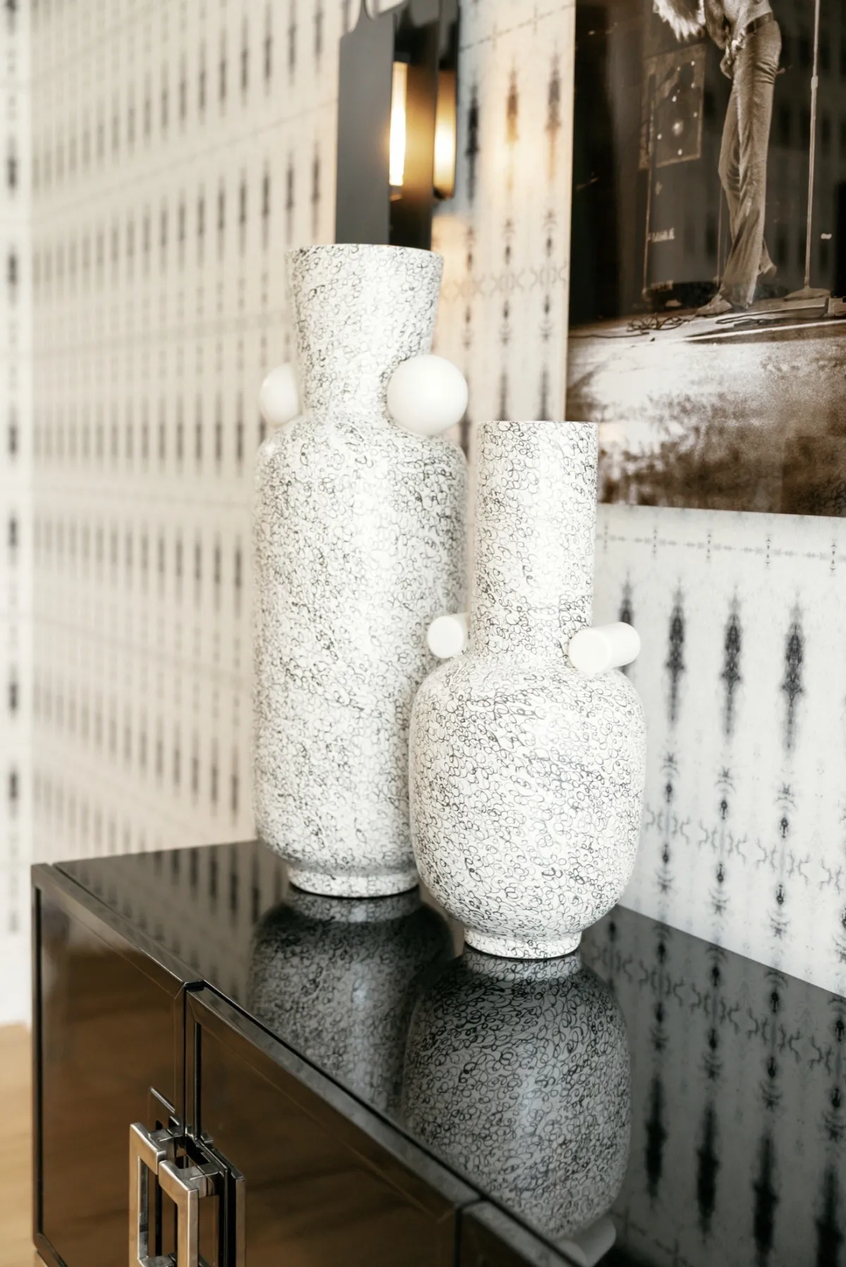 Textured white sculptural vases on a black lacquer console
