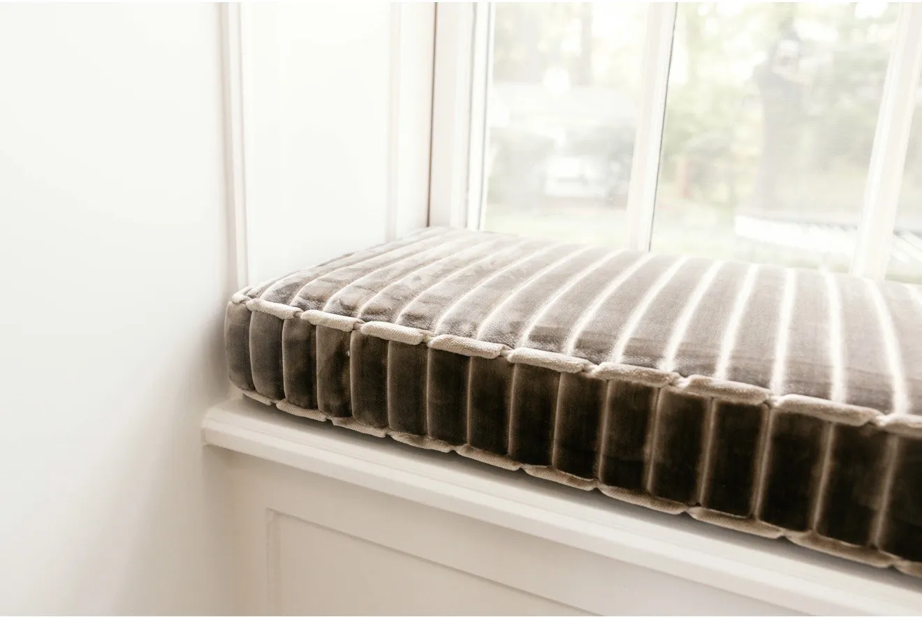 Tailored striped cushion on the window seat
