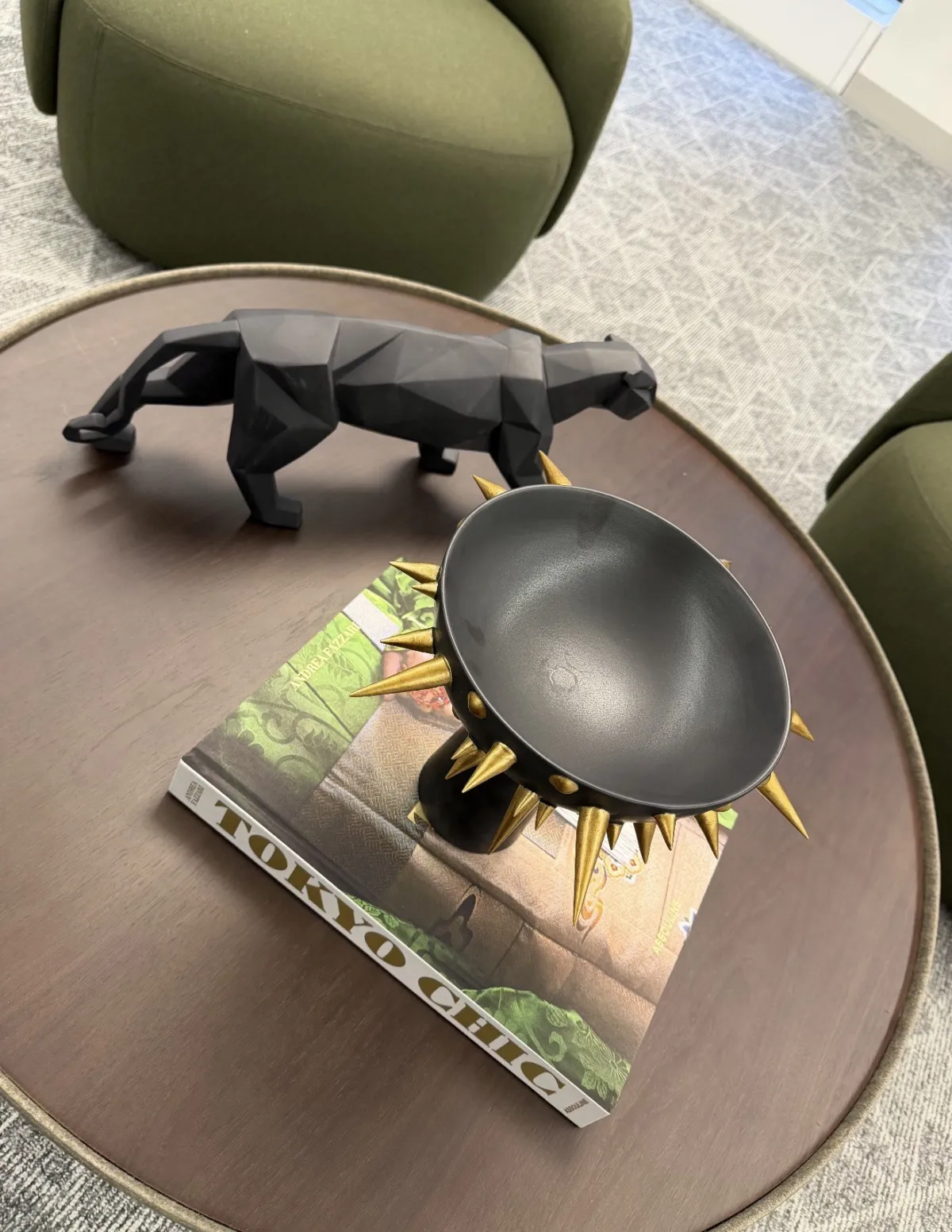 Black panther figurine and a dark bowl on a Tokyo art book